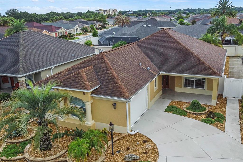 an aerial view of a house with a yard and potted plants