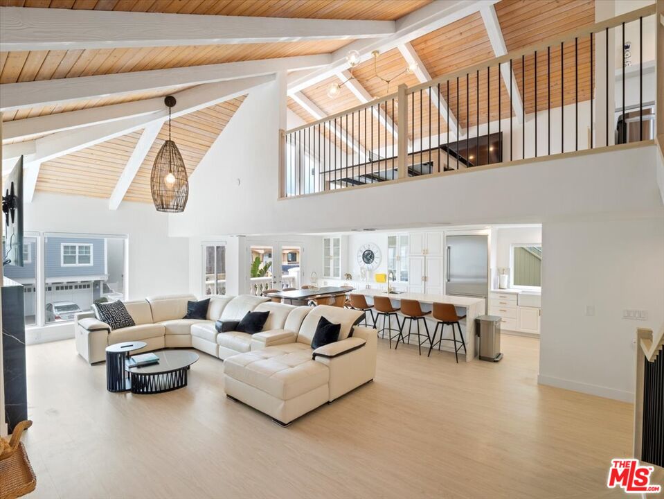 a living room with furniture a fireplace and a chandelier