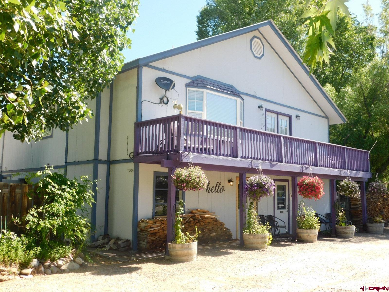 a view of a house with potted plants