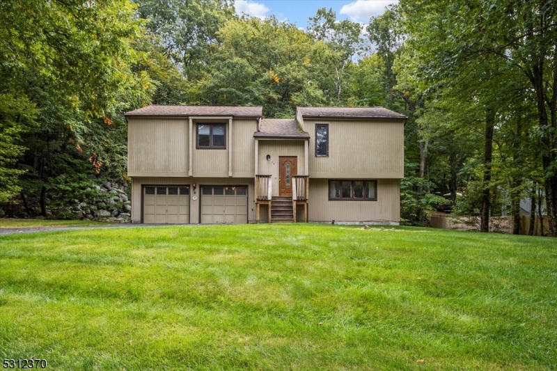 a view of a house with a backyard and a patio