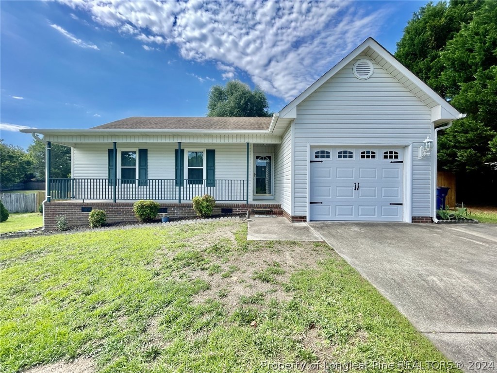 a view of a house with backyard and porch