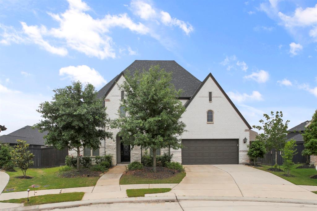 a front view of a house with a yard garage and outdoor seating