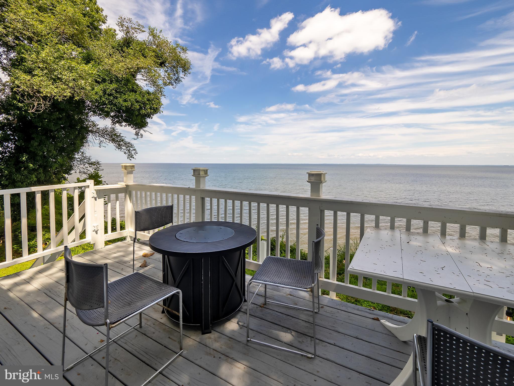 a view of a chairs and table on the deck