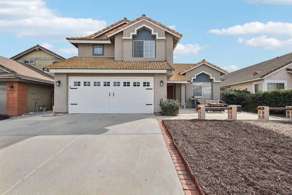 a view of a house with a yard and garage