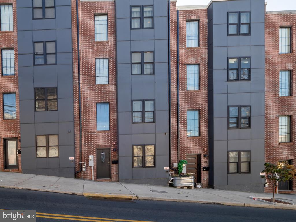 a view of a brick building next to a yard