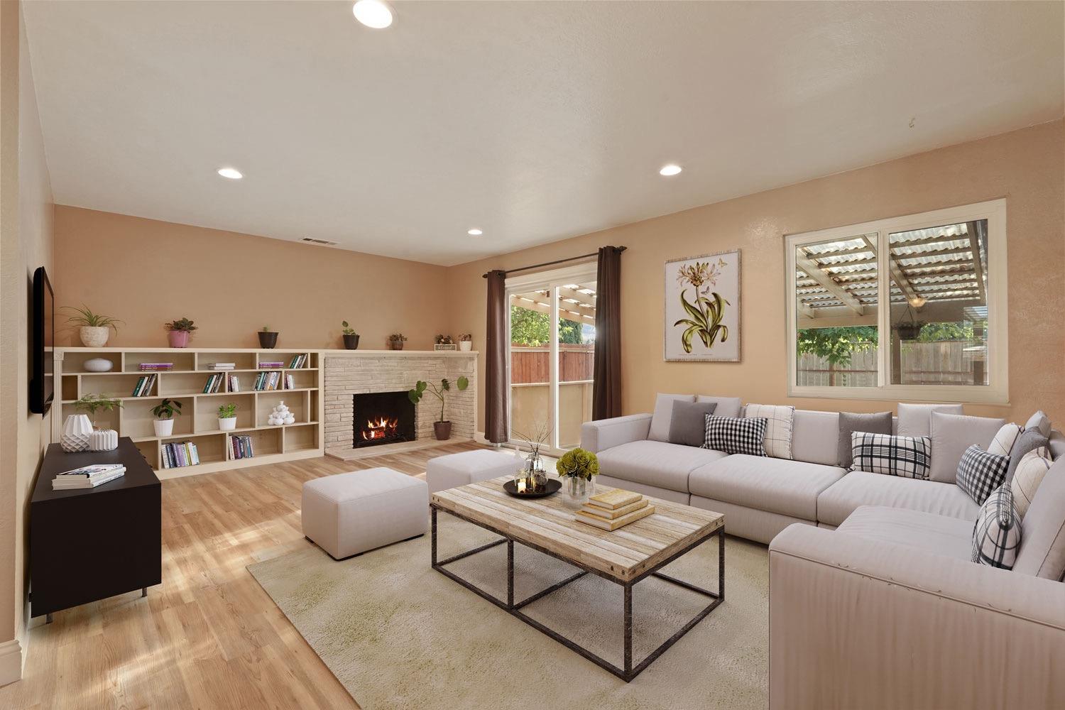 a living room with furniture fireplace and window