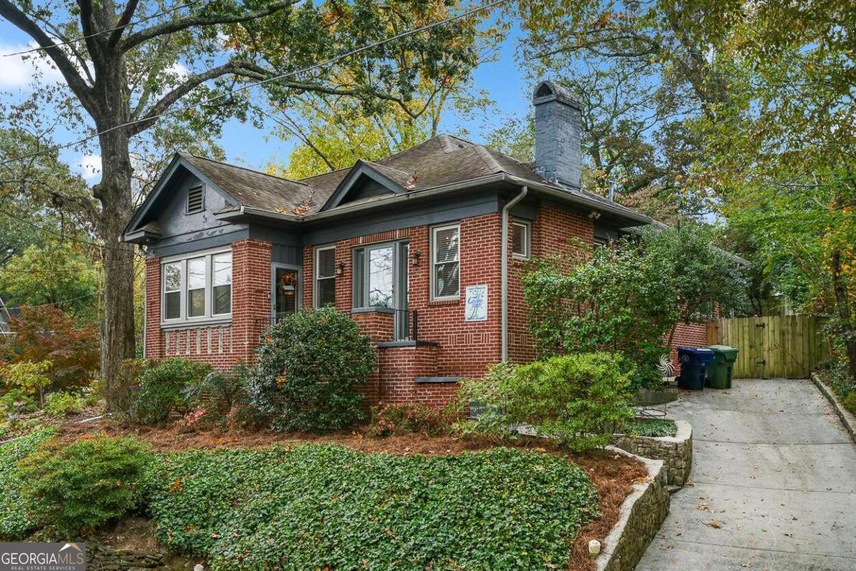 a brick house with trees in front of it