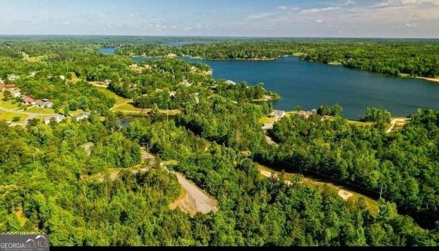 an aerial view of residential houses with outdoor space and swimming pool