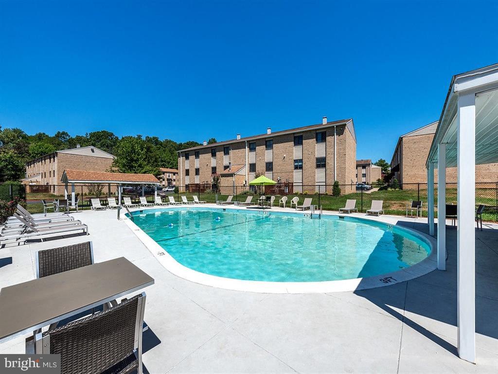 a view of a swimming pool with lawn chairs