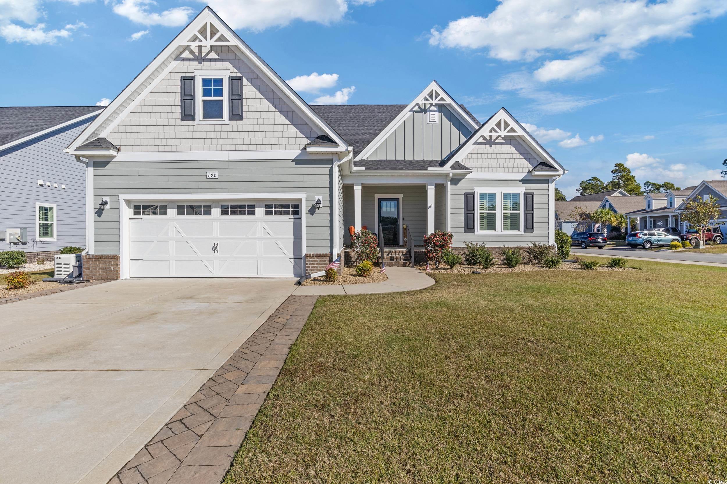 Craftsman-style house with cooling unit and a fron