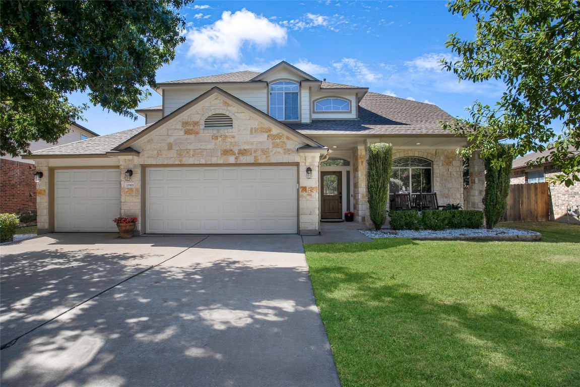 a front view of a house with a yard and garage