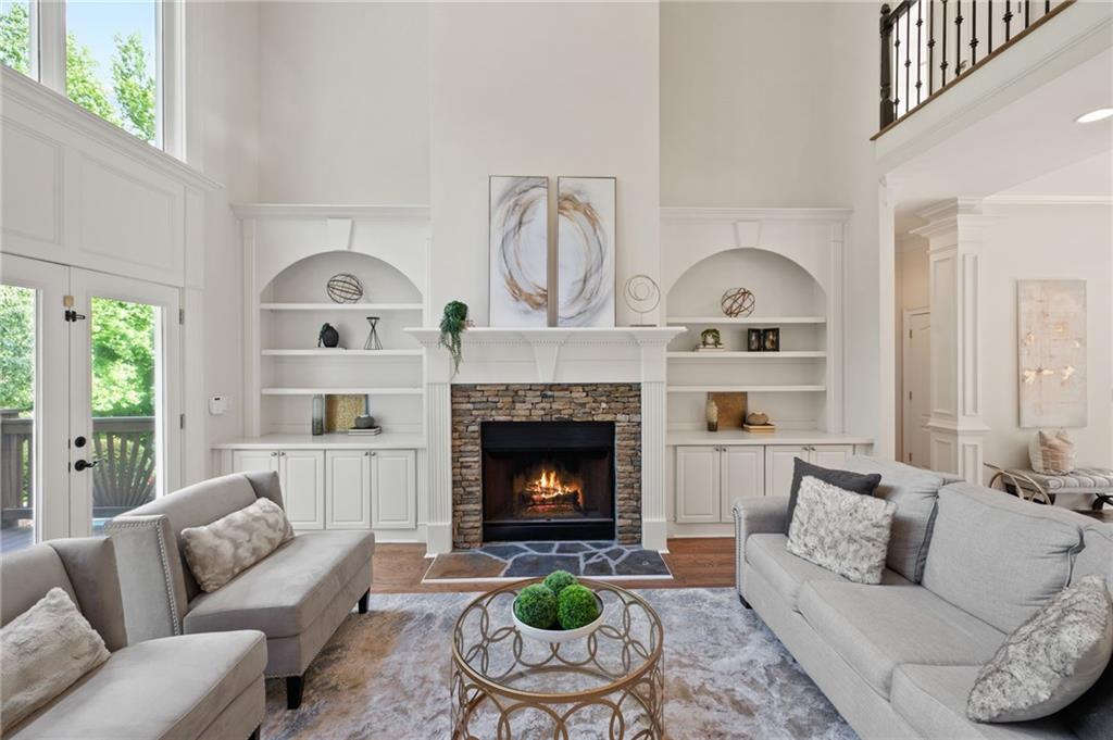 a living room with furniture a fireplace and a window