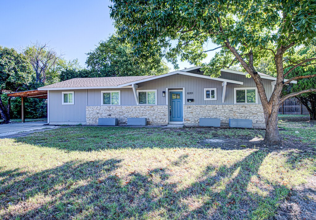 a front view of house with yard and trees