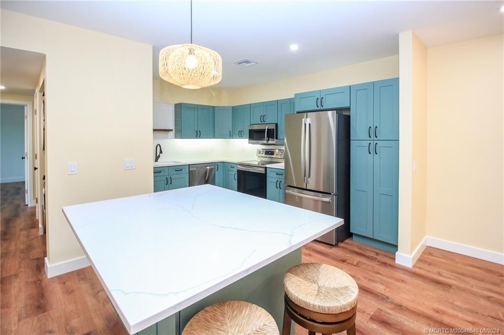 a kitchen with a refrigerator a sink and a stove