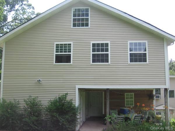 a front view of a house with plants