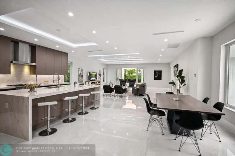 a kitchen with stainless steel appliances kitchen island granite countertop a sink and cabinets