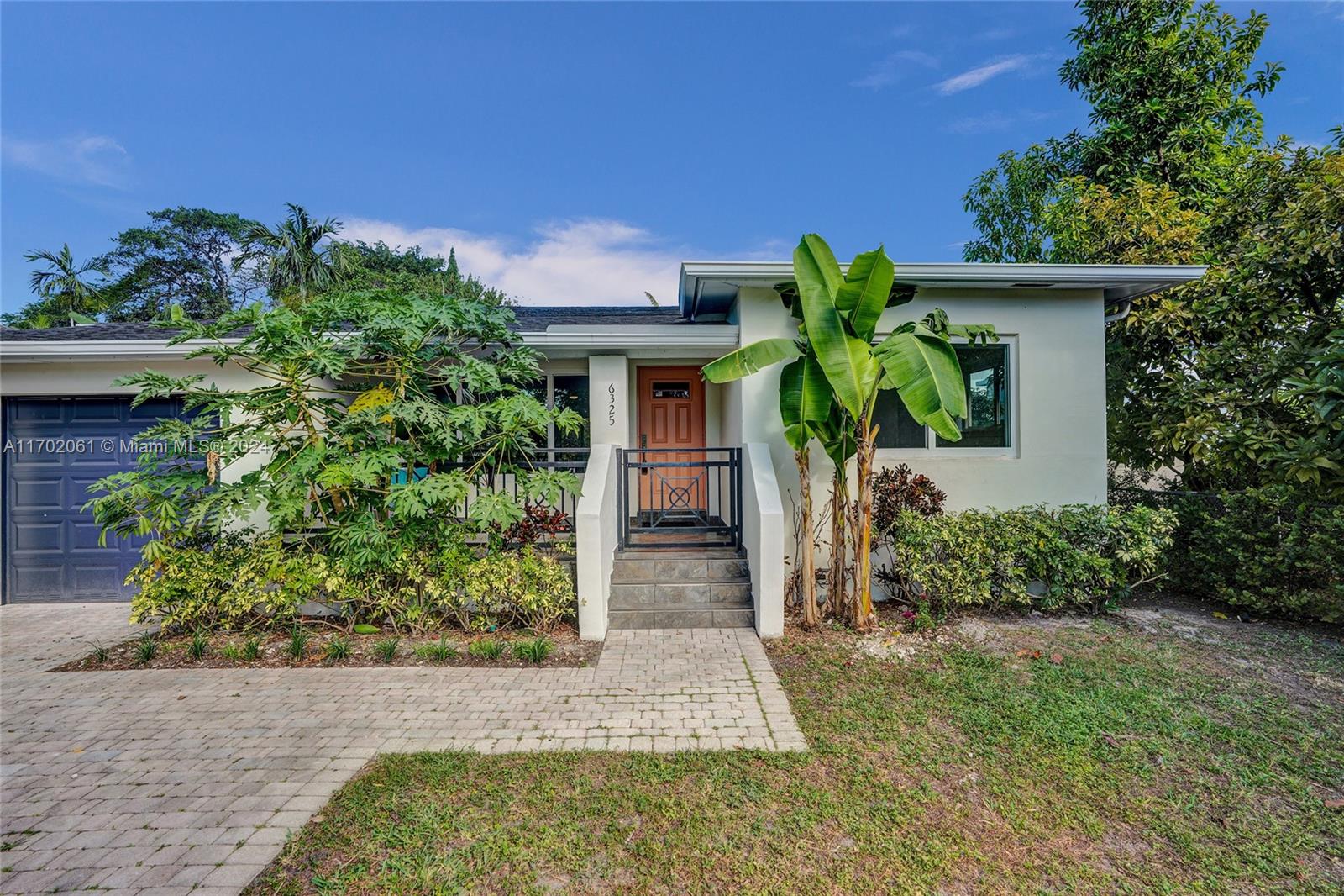 front view of a house with potted plants