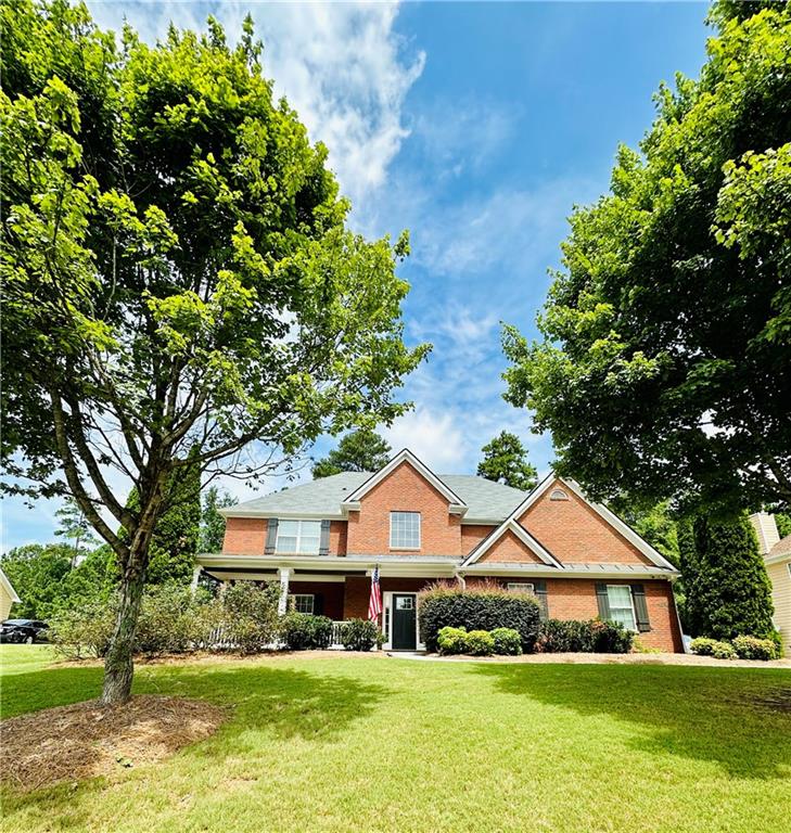 a front view of a house with a yard