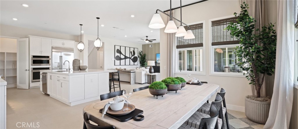 a kitchen with white cabinets and refrigerator