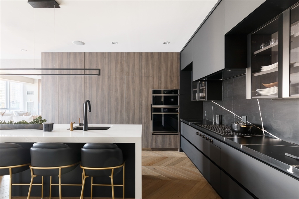 a kitchen with stainless steel appliances a sink and cabinets