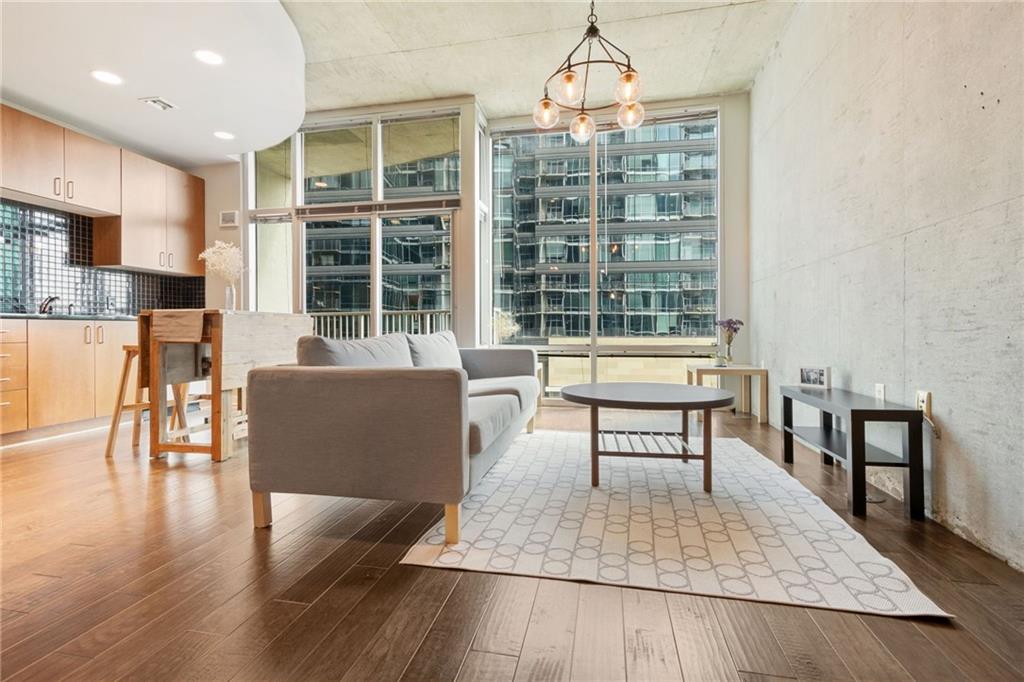 a living room with furniture a window and a dining table