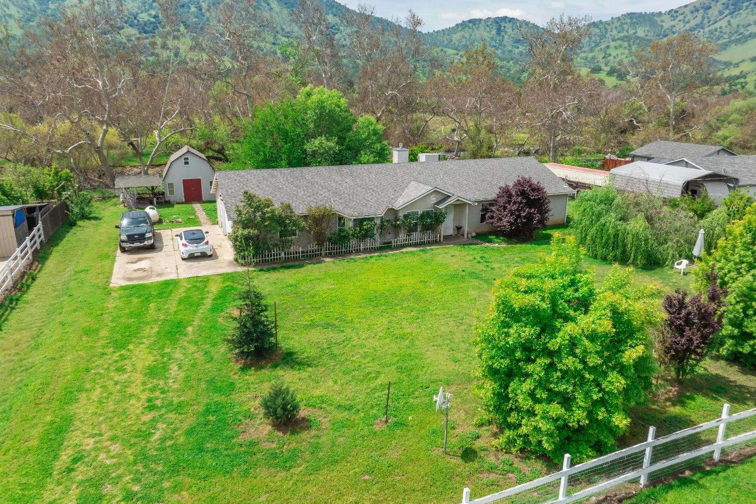 an aerial view of a house with yard swimming pool and mountain view