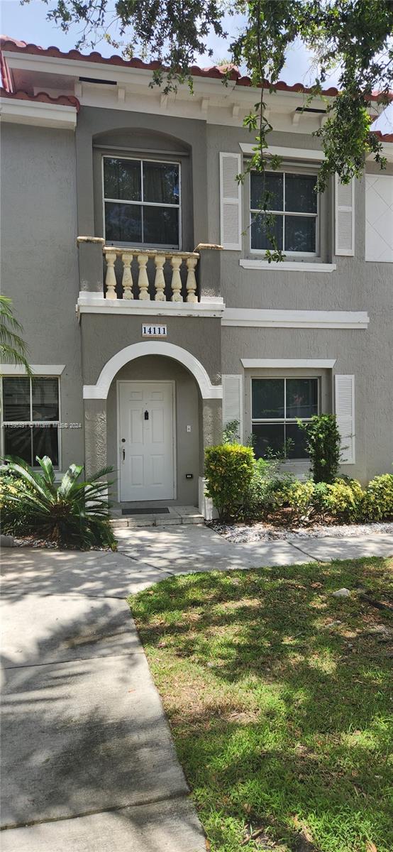 a front view of a house with a yard