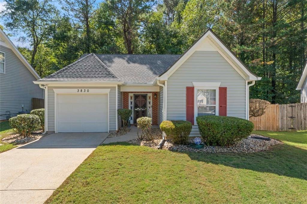 a view of a yard in front of a house with garage