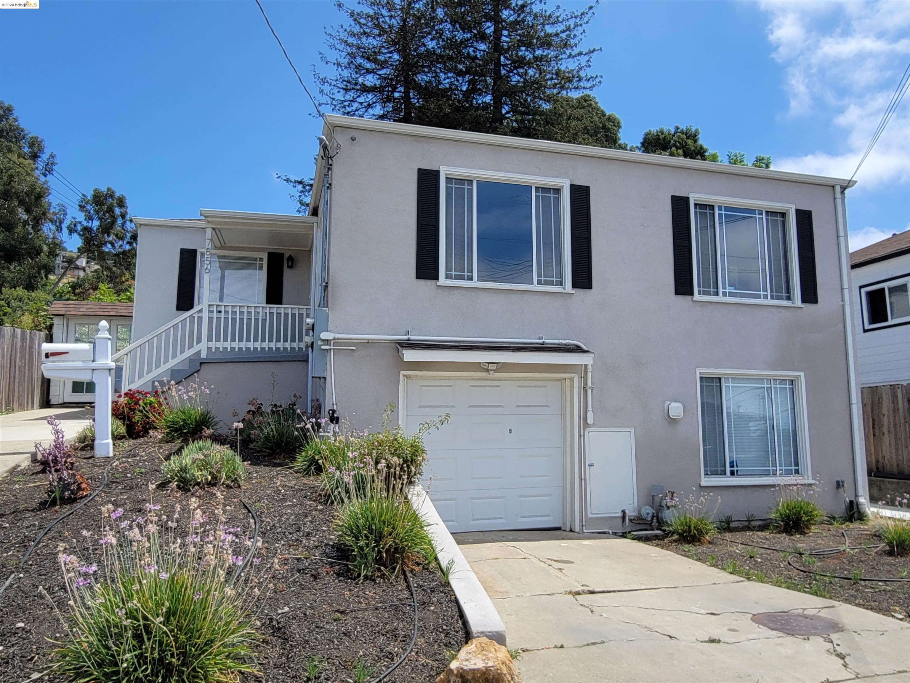 a front view of a house with garden