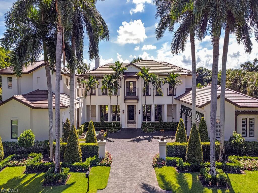 front view of a house with a yard and a fountain