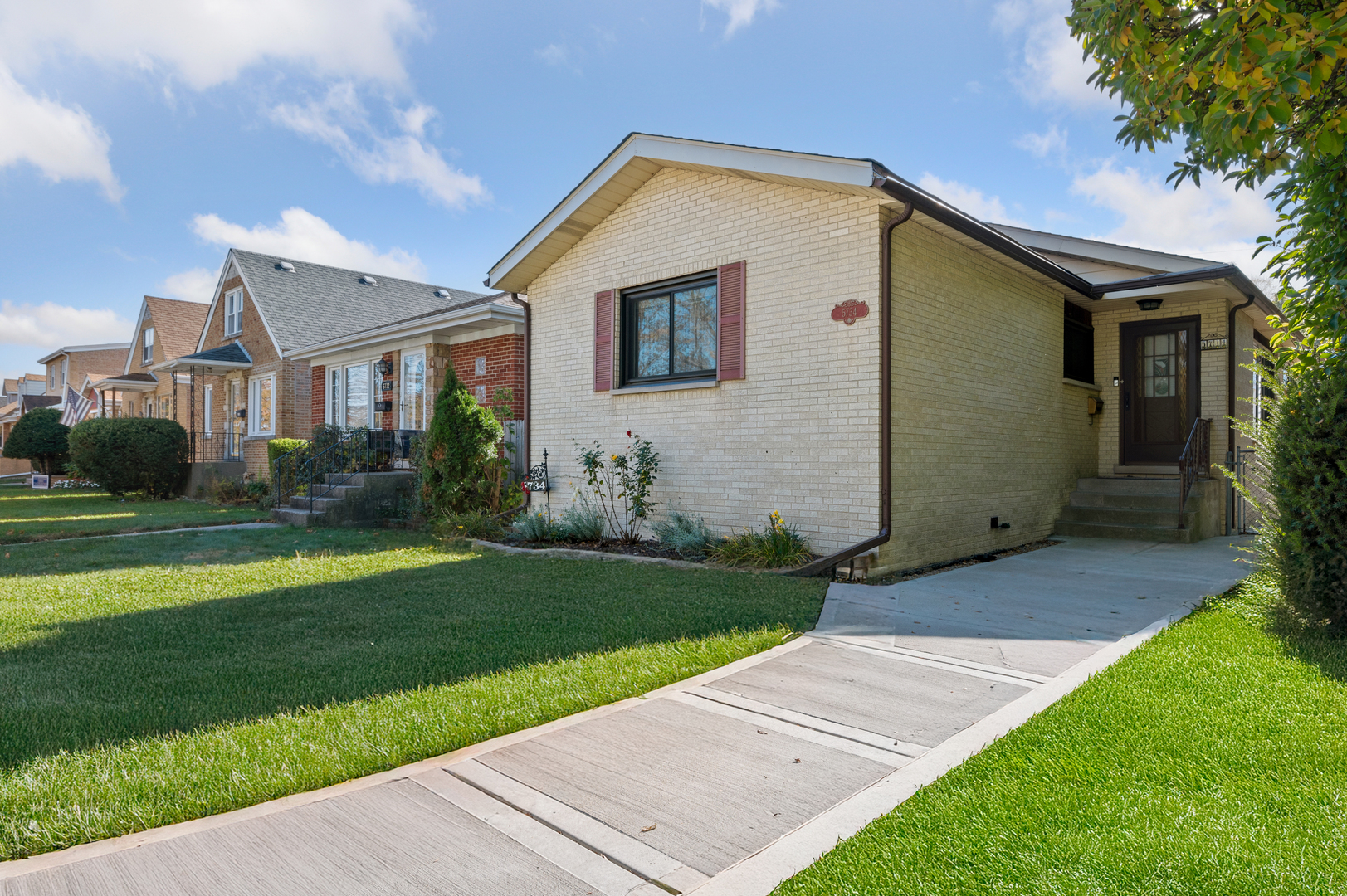 a front view of house with yard and green space