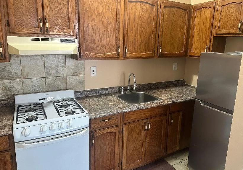 a kitchen with a stove and a refrigerator