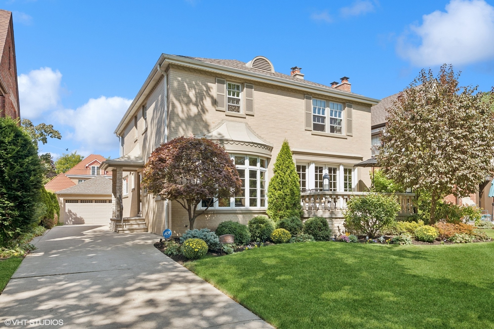 a front view of a house with a garden