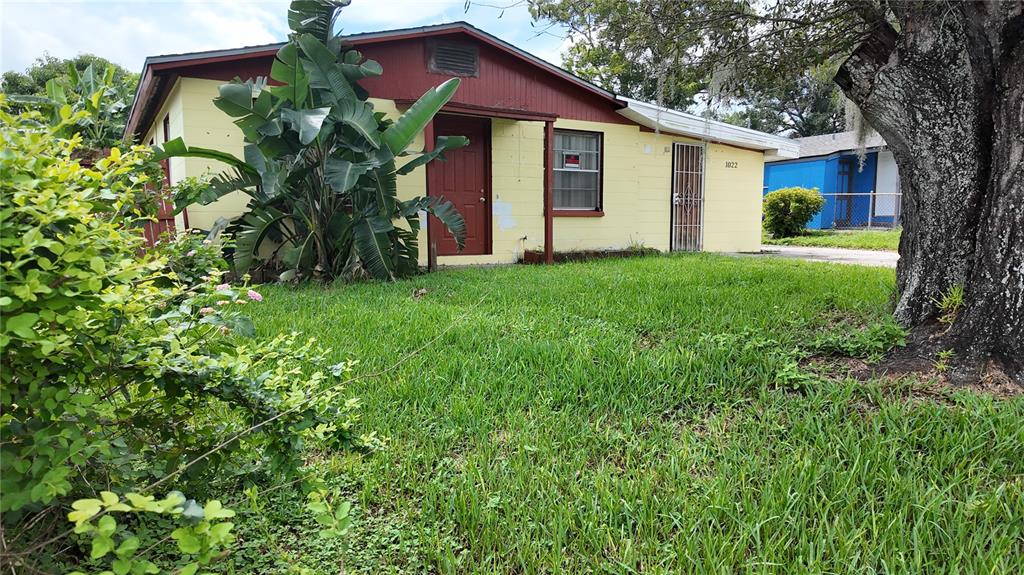 a front view of house with yard and green space