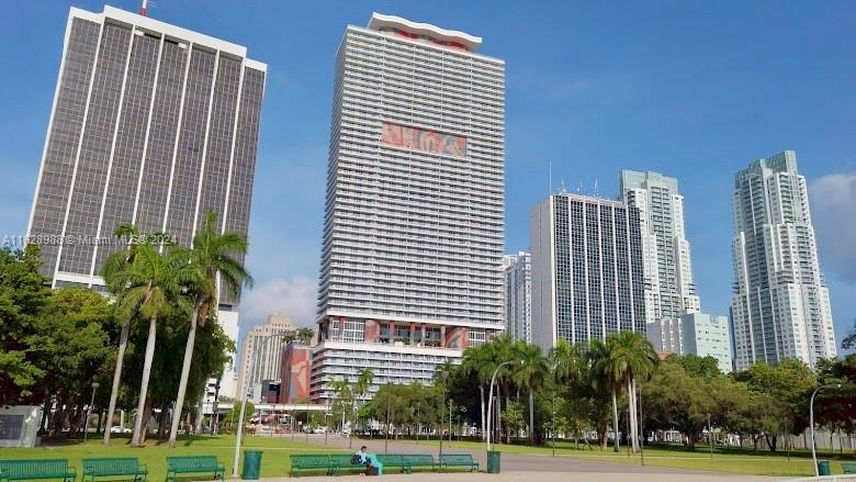 a view of a tall building next to a yard