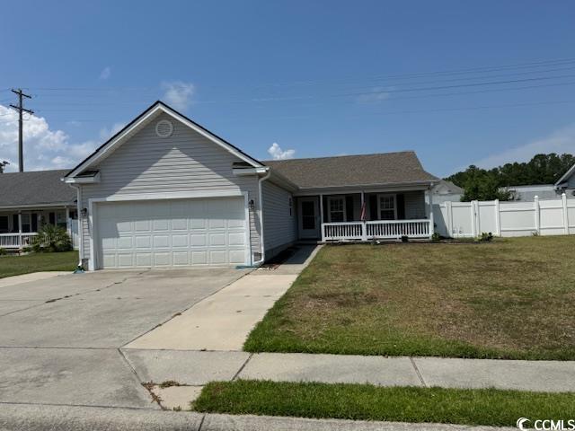 Single story home featuring a front yard and a gar