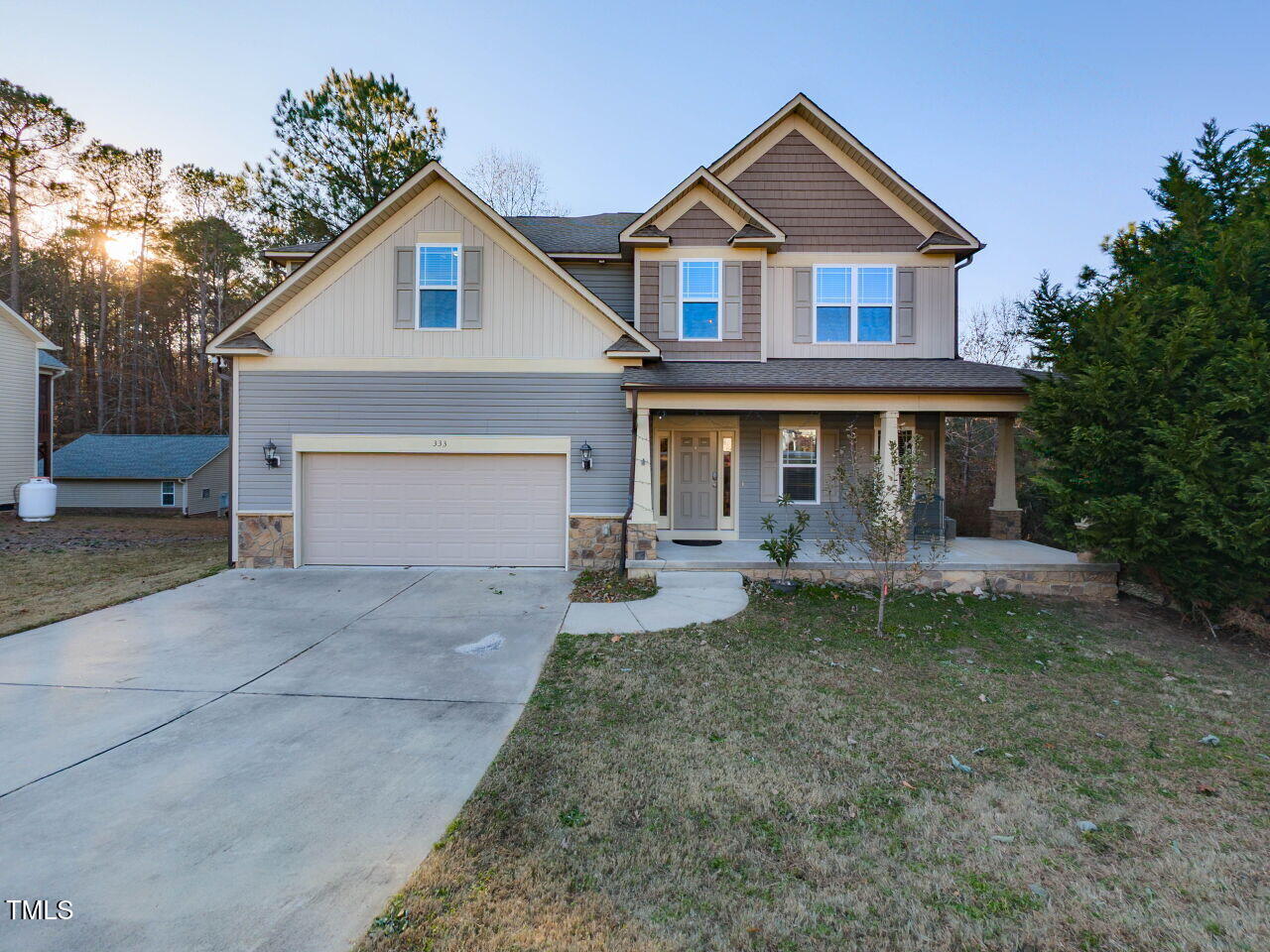 a front view of a house with yard and porch