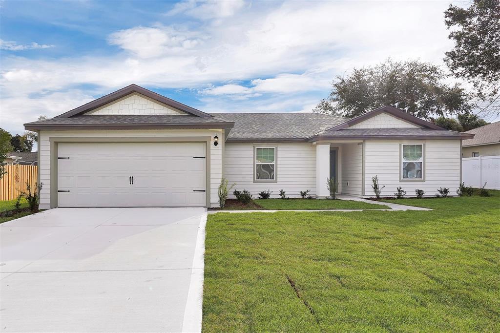 a front view of a house with a yard and garage