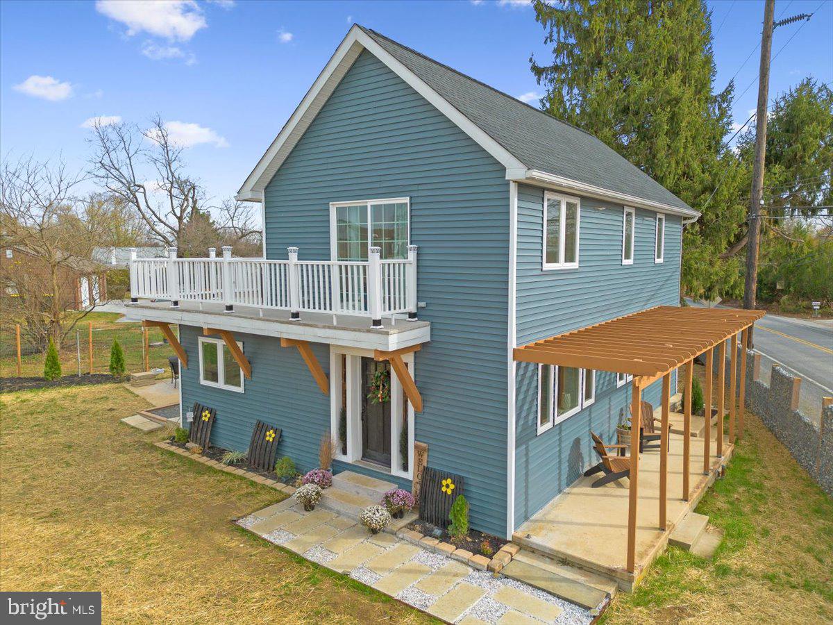 a view of a house with backyard porch and sitting area