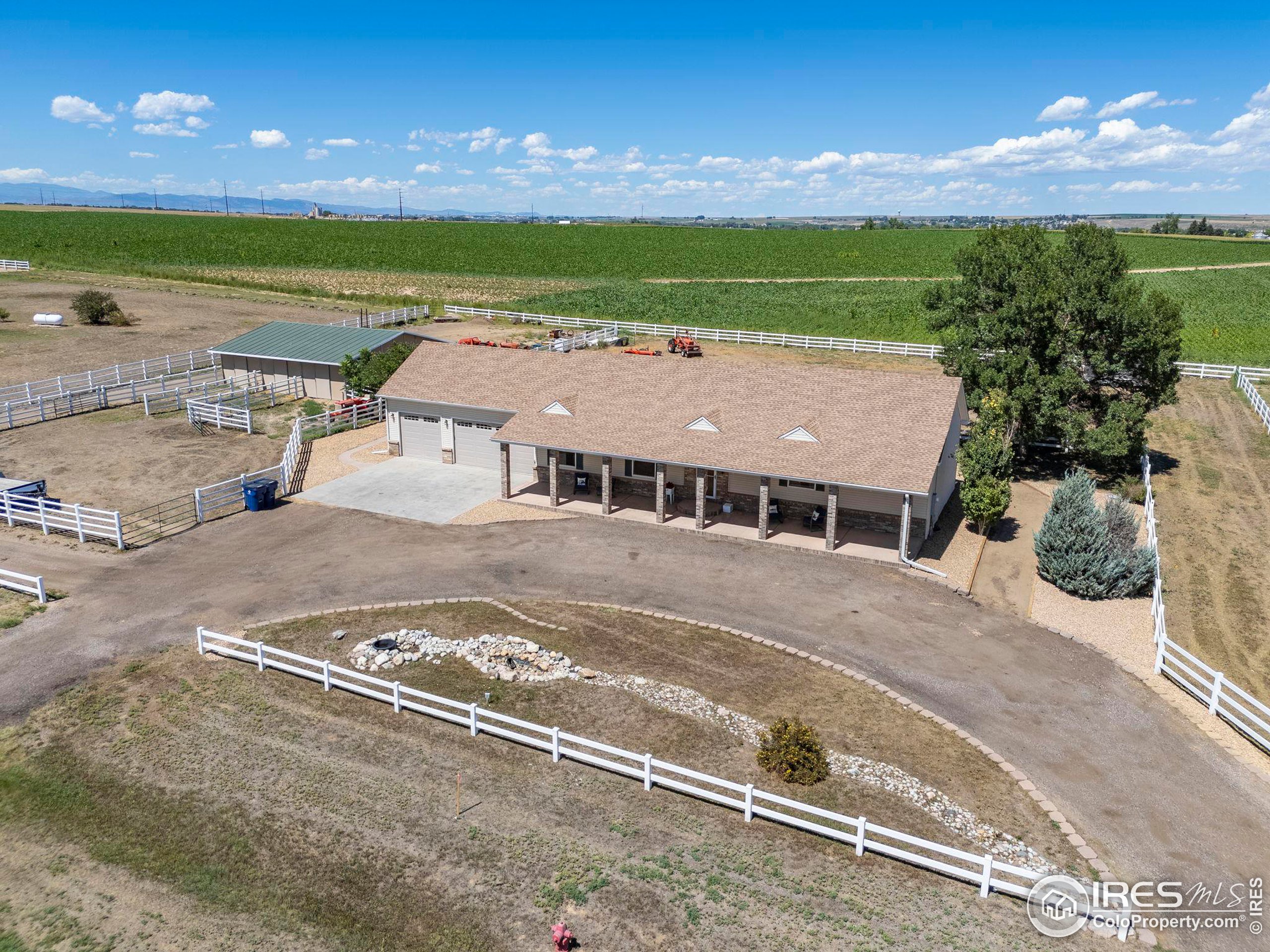 an aerial view of a house with a big yard