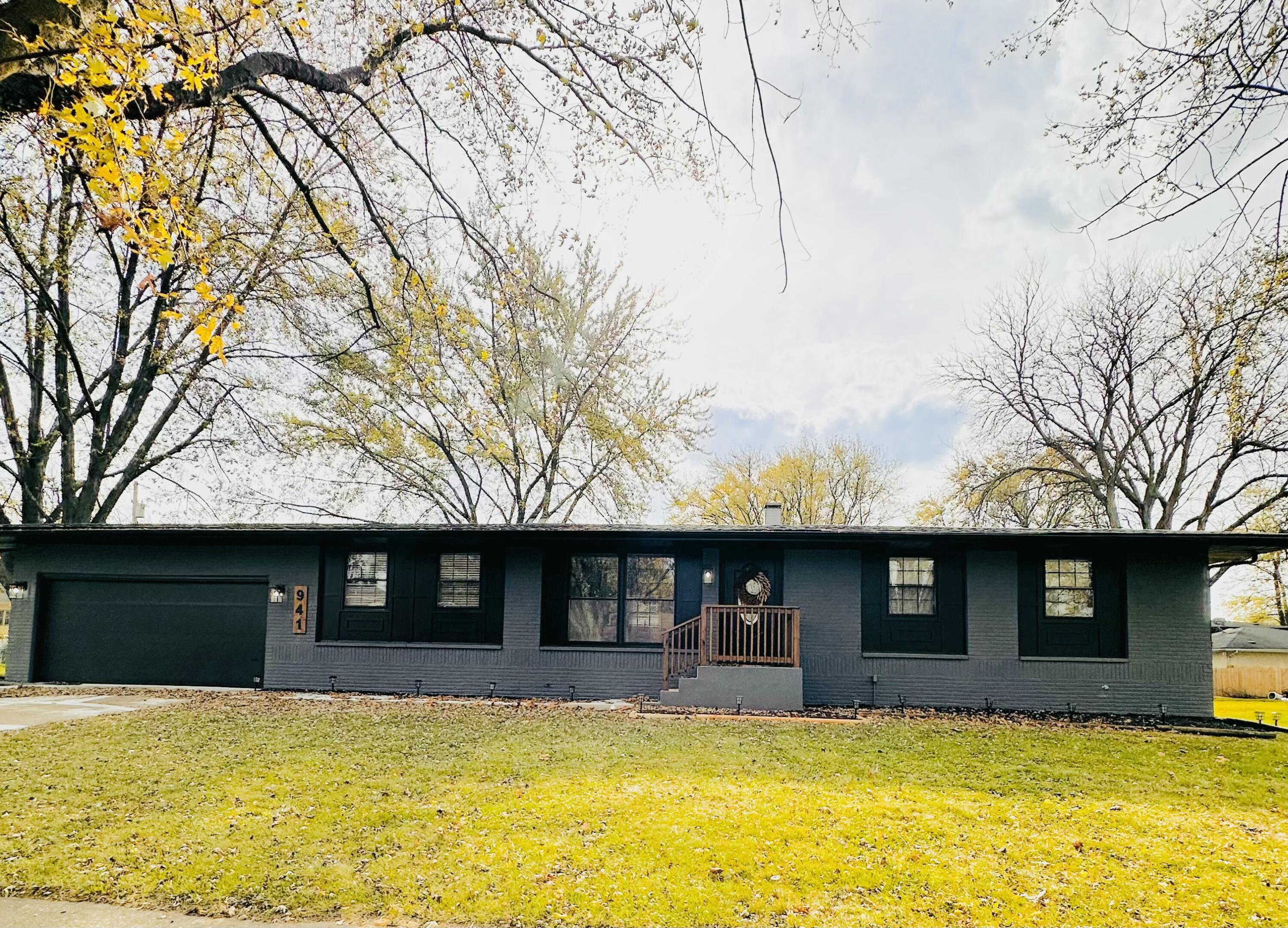 a view of house with a yard