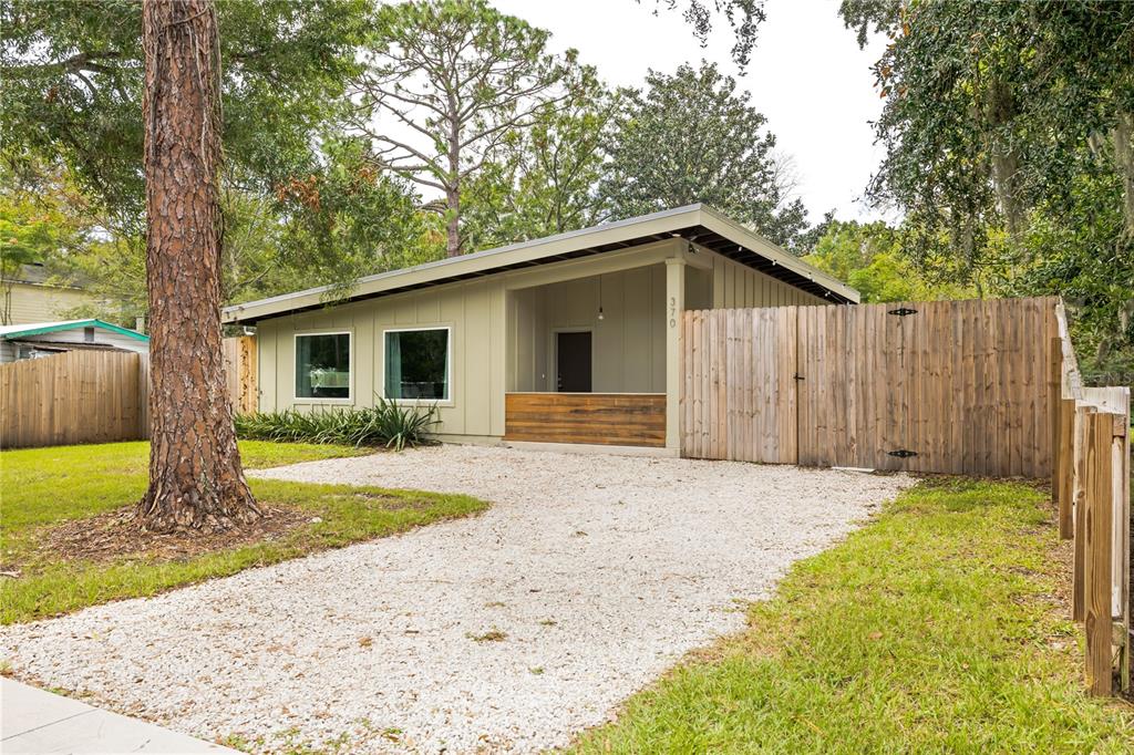 a front view of a house with a garden and yard