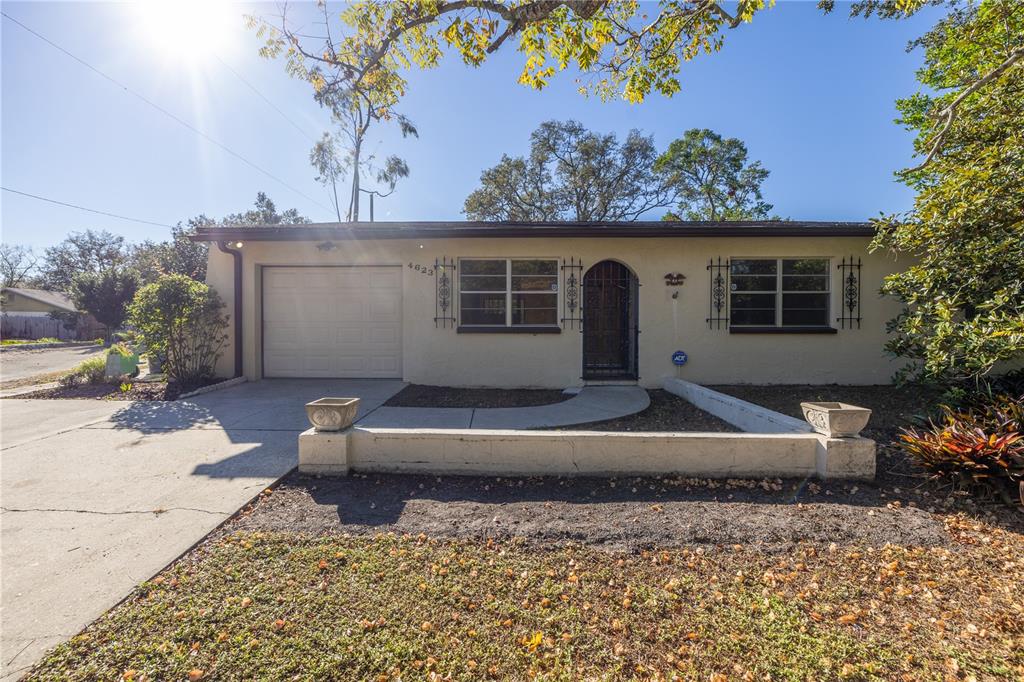 a view of a house with a yard and a fire pit