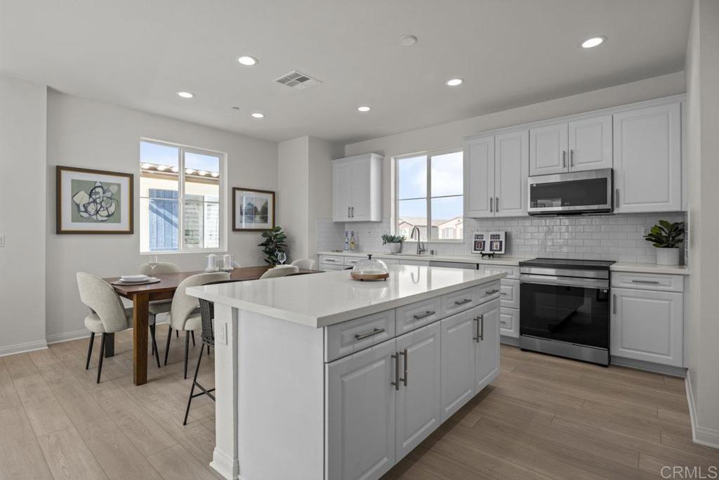 a kitchen with a sink stove and microwave