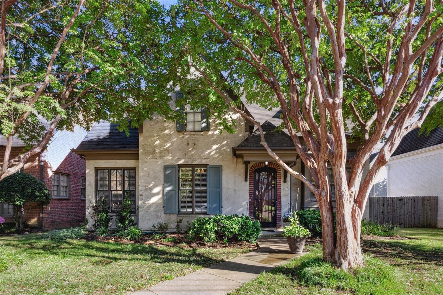 front view of a house with a tree in a yard