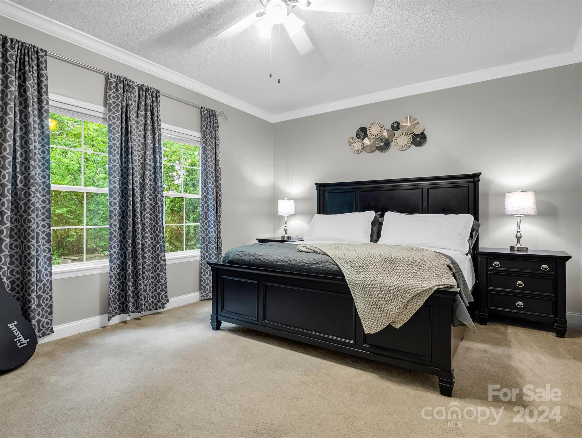 a bedroom with a bed and a large window