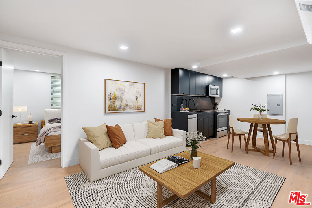 a living room with furniture and kitchen view