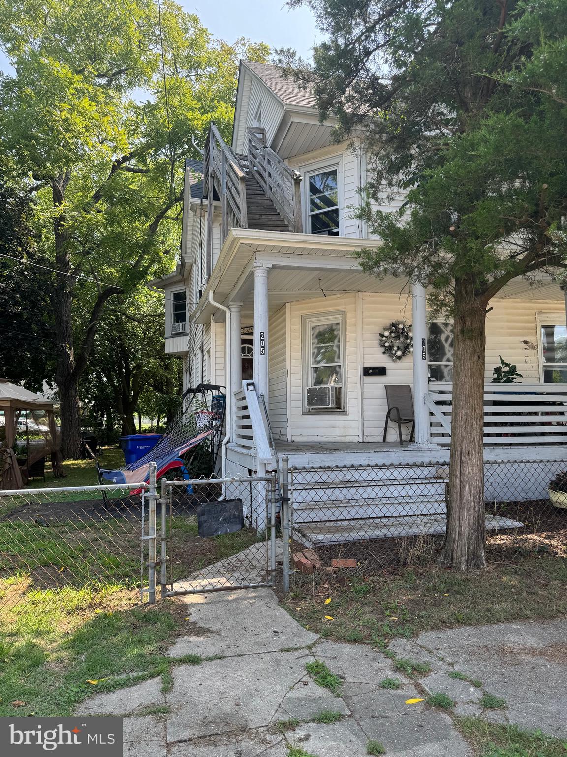 a view of house with pool and bench