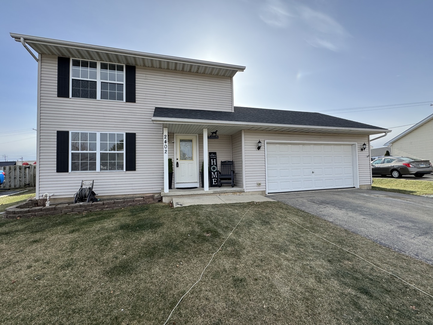 a view of a house with a yard and garage