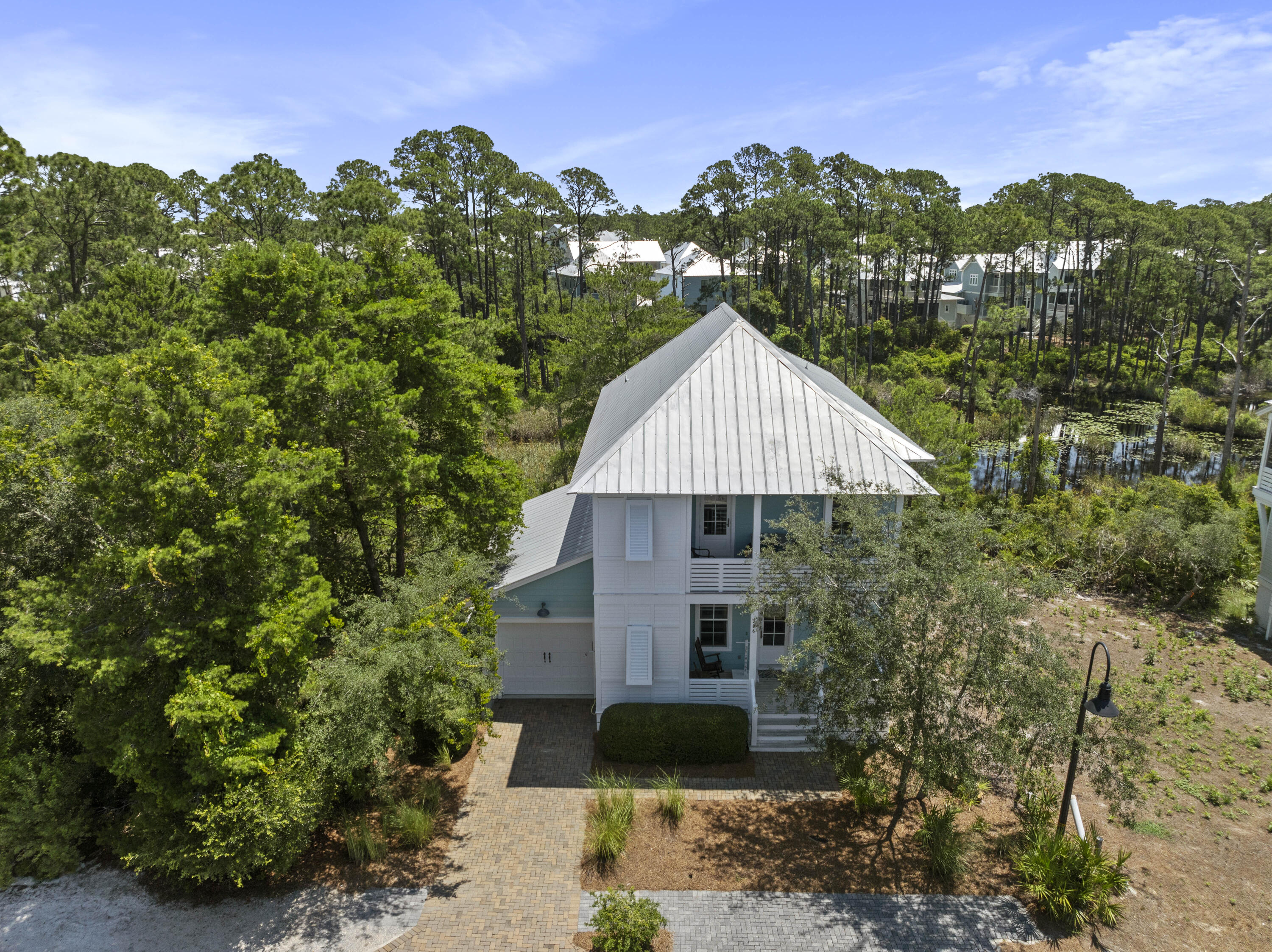 a aerial view of a house with a yard and potted plants